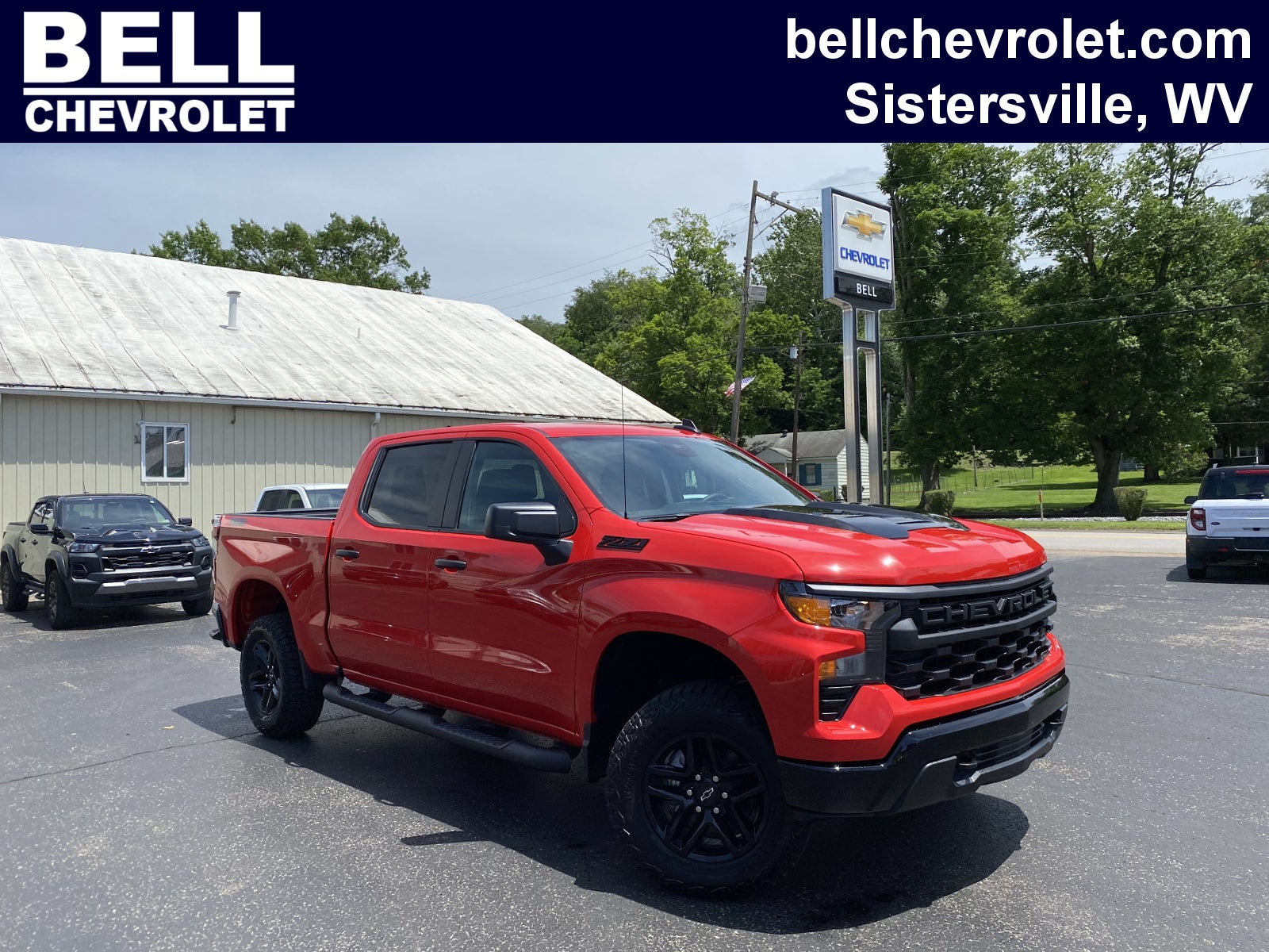 2026 Chevrolet Silverado 1500 Custom Trail Boss in Red Hot — front three-quarter view